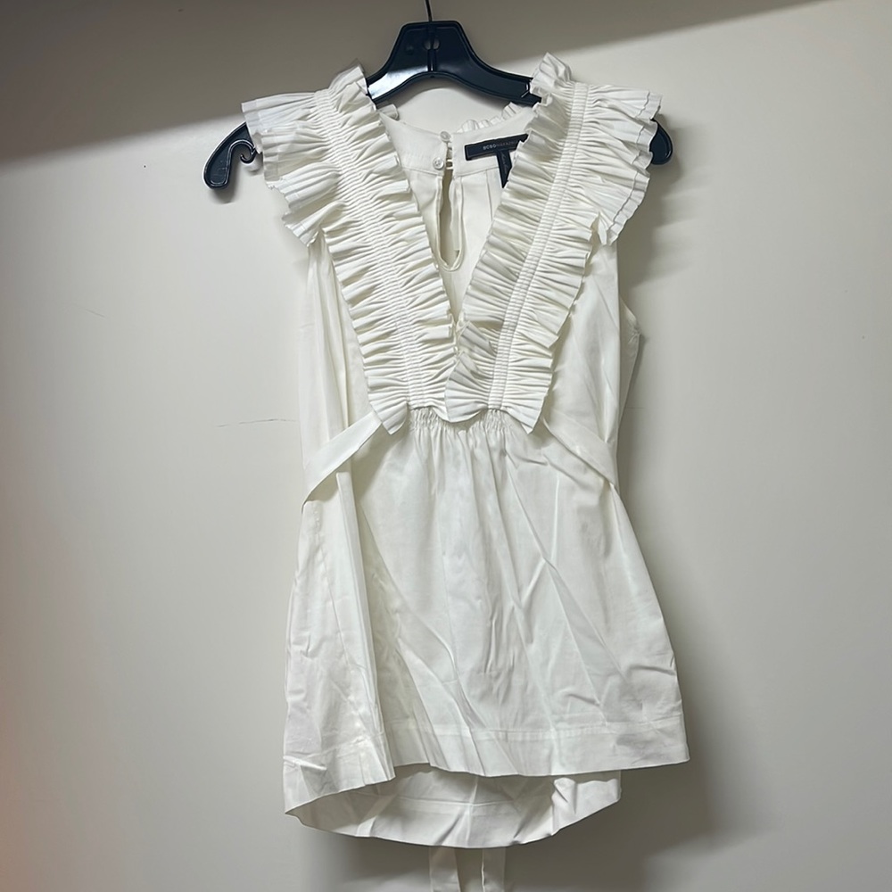 BCBG darling, ruffle top that ties at back perfect with jeans or a skirt